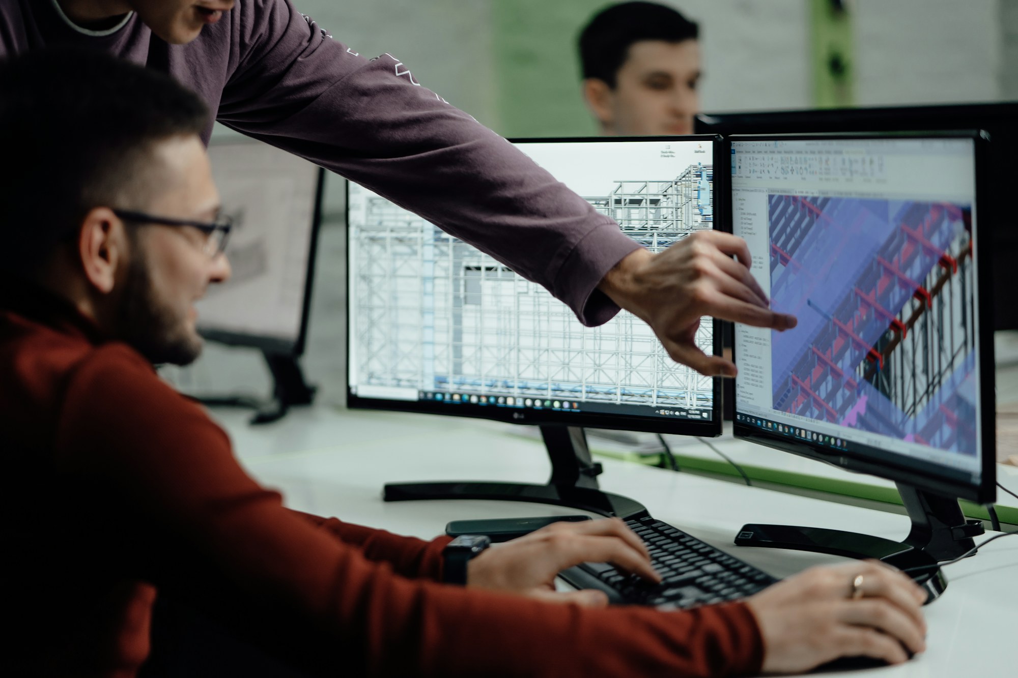Engineers reviewing a structural model on screen