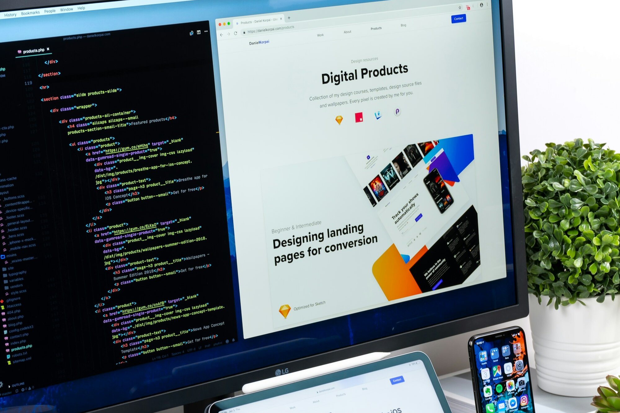 Website code and a landing page design on a monitor, with a tablet and phone